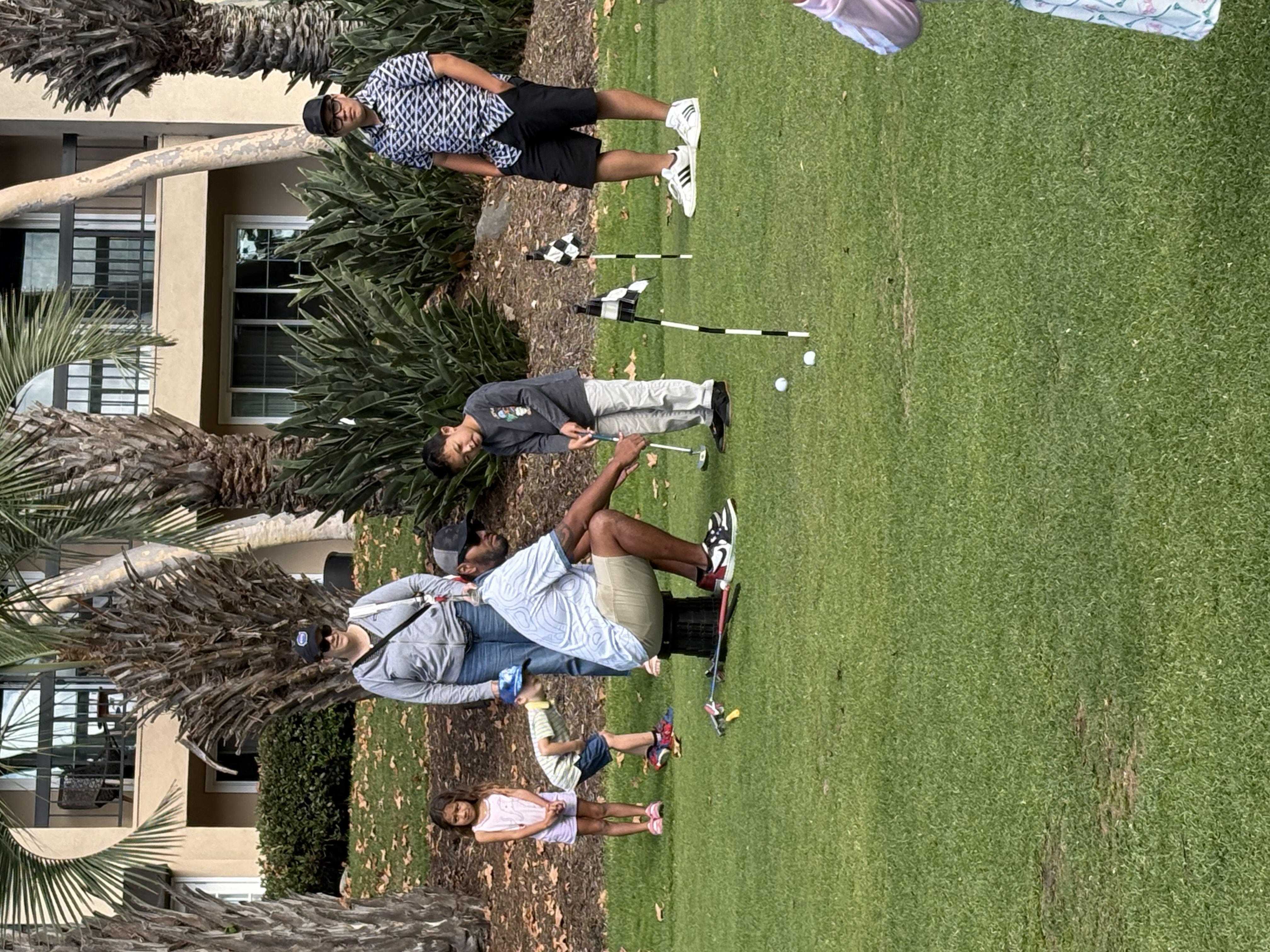 Lead Coach Channing helping a young player with a putt.